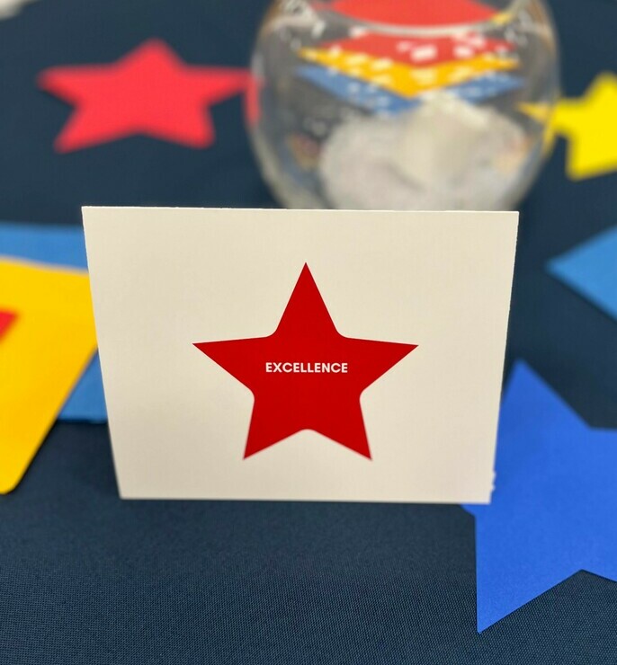 stars on a table with a place card with the word excellene